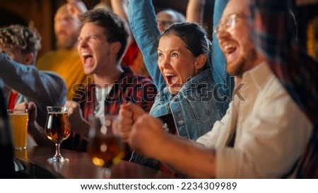 Group of Diverse Friends Cheering for Their Team, Drinking Beer at a Pub Counter. Supportive Fans Cheering, Applauding and Shouting. Joyful Friends Celebrate Victory After the Goal. Royalty-Free Stock Photo #2234309989