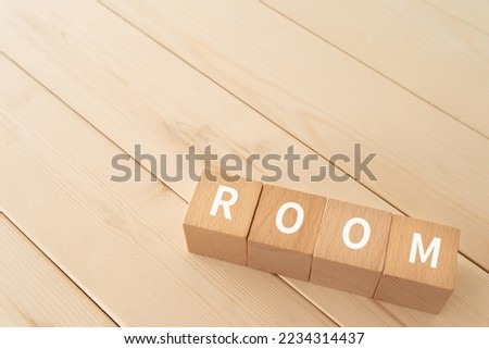 Wooden blocks with "ROOM" text of concept. Royalty-Free Stock Photo #2234314437