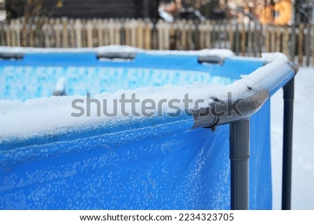Swimming pool in winter in snow and ice