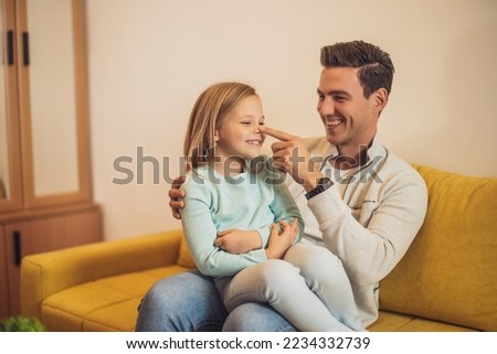 Happy father and daughter spending time together and having fun at their home. Royalty-Free Stock Photo #2234332739