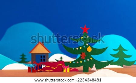 Santa's bag with gift boxes falls under a Christmas tree with a garland and decorations on a background of snow-capped mountains