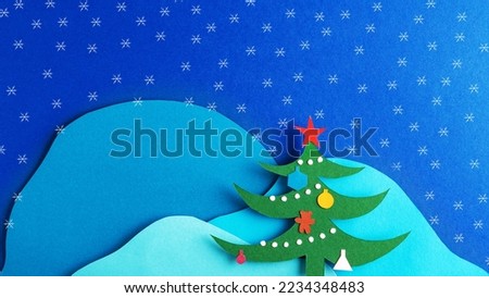 Christmas card with decorated Christmas tree and snowflakes on the background of mountains