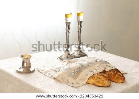 Shabbat image - silver candlesticks Lightened with olive oil, Silver kiddush cup and challah