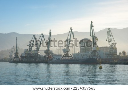 Batumi sea port with cranes silhouettes, ships, ferries at sunrise. Logistic, industry, shipping, trade concept Royalty-Free Stock Photo #2234359565
