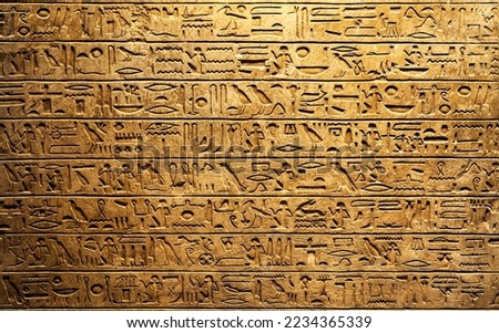 Old Egyptian hieroglyphs on an ancient background. Wide historical and culture background. Ancient Egyptian hieroglyphs as a symbol of the history of the Earth.  Royalty-Free Stock Photo #2234365339