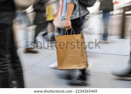 Motion blur power, man walking with paper bag