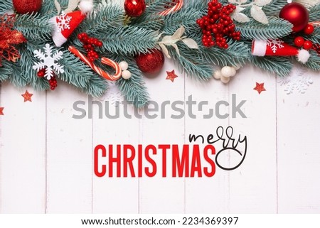 Merry Christmas greeting card with composition made from pine tree, stars and festive decorations top view.