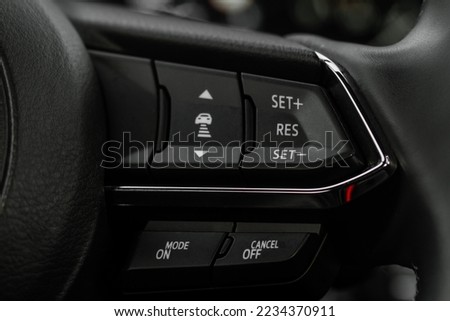 Cruise control switch closeup. Adaptive cruise control leaver. Cruise control on steering wheel. Royalty-Free Stock Photo #2234370911