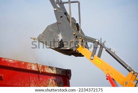 an excavator's bucket. excavator during work. detail. time photo from a working site.