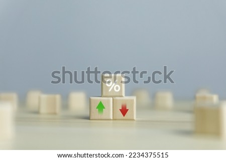 Wooden cube blocks with percentage icons and up or down arrows. business concept finance economy mortgage Bank interest rates, loans, investments, stock growth, and dividends.