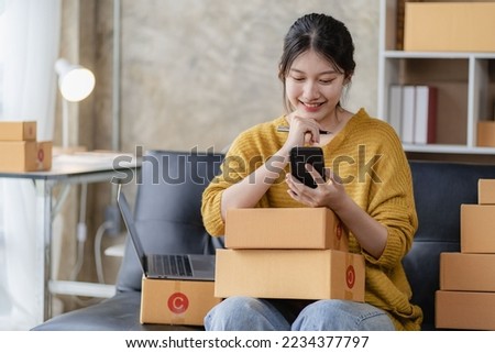 
Asian woman taking orders over the phone Online sales, delivery, marketing. Excited young Asian entrepreneurs with digital laptops while working from home. Small business Startup SME