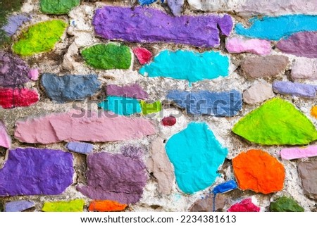 Colorful painted rough stone wall