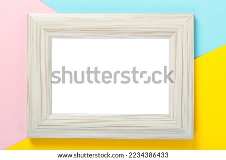 Blank wooden white photo frame on colourful background, save clipping path.