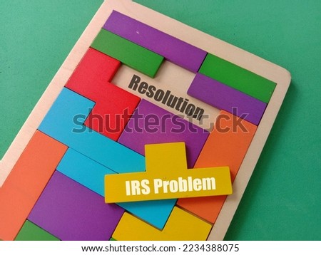 IRS Problem  text at yellow puzzle and Resolution text at space of wooden puzzle isolated green background 