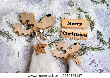 Merry Christmas greeting  card  with wooden deer 