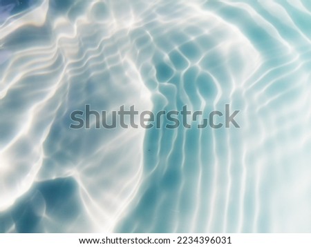 Closeup blur​ abstract​ of​ surface​ blue​ water​ in​ the​ deep​ sea​ for​ background. The​ pattern​ of​ blue​ water​ for​ background. Abstract​ of​ surface​ blue​ water for​ background.