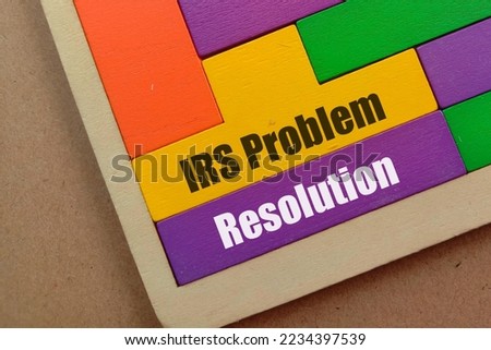 Business Concept - IRS Problem Resolution text at yellow and purple wooden puzzle isolated brown background 