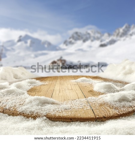 Wooden board of free space cover of snow flakes and landscape of mountains. Cold winter day and sunny day. 