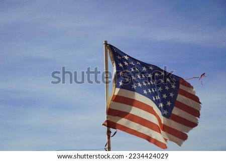Weathered US Flag in the wind. 