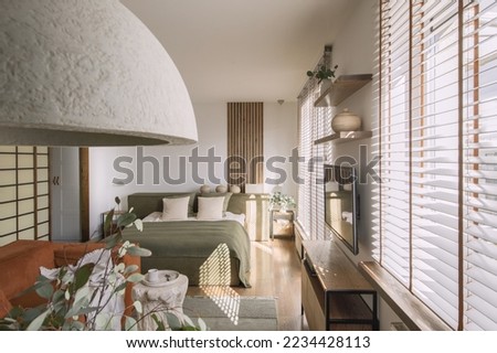 Modern Japandi appartment interior design in earth tones, natural textures with wooden solid oak furniture and sliding Japanese wood doors. Japandi concept Royalty-Free Stock Photo #2234428113