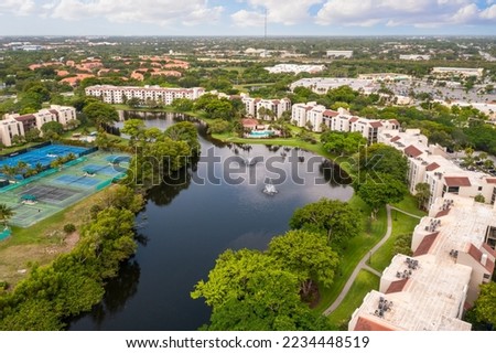 Aerial drone view to the suburbs in Delray Beach in Miami Florida, there is large tropical vegetation, houses with tiles Royalty-Free Stock Photo #2234448519