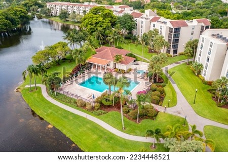 Aerial drone view to the suburbs in Delray Beach in Miami Florida, there is large tropical vegetation, houses with tiles Royalty-Free Stock Photo #2234448521