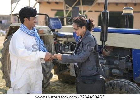 Indian farmer purchasing tractor from insurance agent