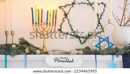 Beautiful decorations for Hanukkah celebration on fireplace in light room