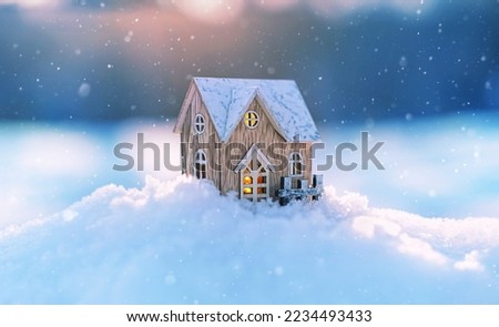 Wooden toy house on snow, natural abstract background. winter season concept. Christmas and new year holidays. symbol of cozy, loving family home. construction, sales, rental concept. copy space