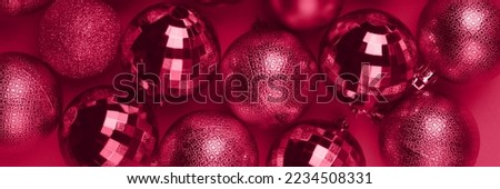 Christmas banner with viva magenta glitter bauble balls on carmine red background. Wide panoramic header