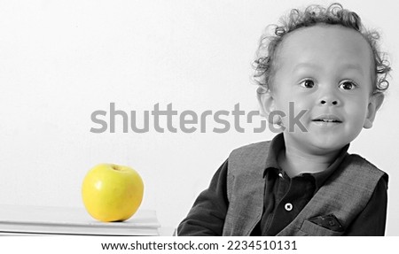 little boy eating apple with white background with people stock photo 