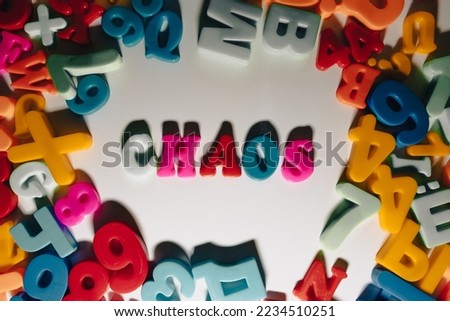 Collected word "Chaos" from multi-colored magnetic letters. The word "CHAOS" from multi-colored letters on a white background