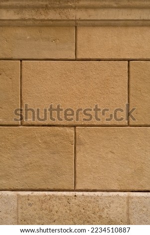 Background texture of restored old wall, orange rectangular blocks. vertical photo.