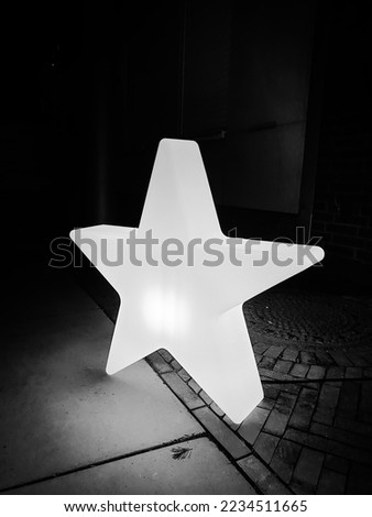 An illuminated star in the street