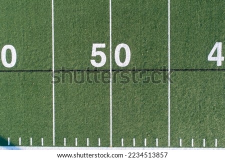 50 yard line of a grass football field from an aerial view Royalty-Free Stock Photo #2234513857