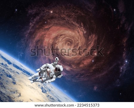 Earth, astronaut and bright spiral galaxy with stars in space. Sci-fi high resolution space wallpaper. Elements of this image furnished by NASA 