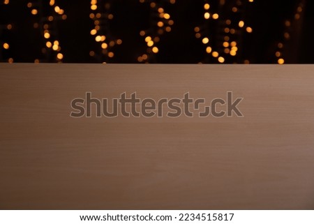 photo edge of the world wooden table in the background festive illumination blurred in bokeh