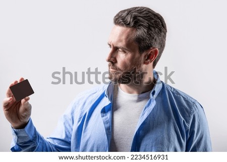 photo of guy look at business card. guy show business card isolated on studio background