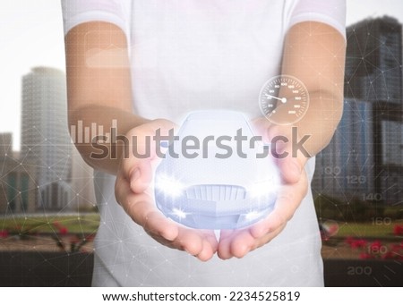 Woman holding digital image of modern car outdoors, closeup