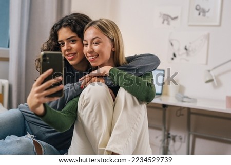 two good friends take a picture together on the phone