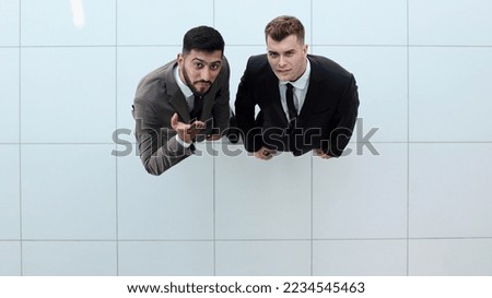 Portrait of two concentrated businessmen partners dressed in formal suit