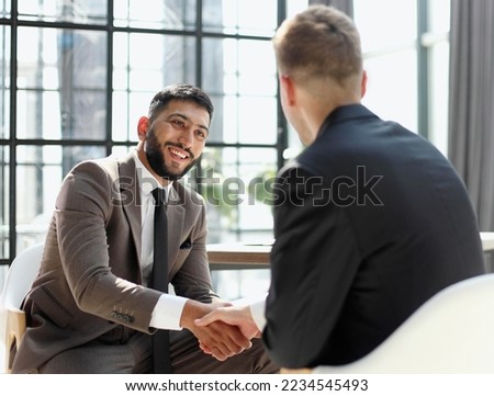 Business shaking hands, finishing up meeting. Successful businessmen handshaking after good deal. Royalty-Free Stock Photo #2234545493