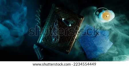 Mystical book of magic and tarot cards for divination on a dark table. Panoramic mockup for your logo. Horizontal banner with copy space for popular social media website cover image.