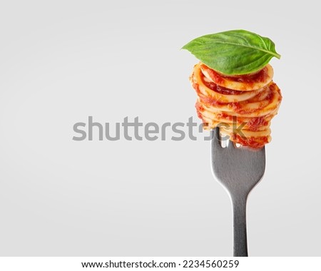 Pasta with tomato sauce on a fork Royalty-Free Stock Photo #2234560259