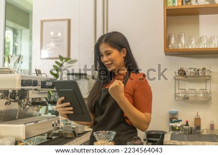 Young female startup owner uses laptop to enhance her e-market. Business woman substitutes paper work by using digital device to promote her shop. Use of application or software in business