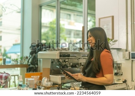 Young female startup owner uses laptop to enhance her e-market. Business woman substitutes paper work by using digital device to promote her shop. Use of application or software in business