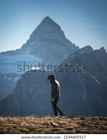 Young pilgrim on top of a hill with background massne and pleasant mountains Mout Assinibine, East Kootenay, British Columbia, Canada Royalty-Free Stock Photo #2234605517