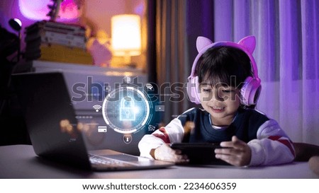Child safety online. Little girl using smartphone at home. icon of internet blocking app on foreground Royalty-Free Stock Photo #2234606359