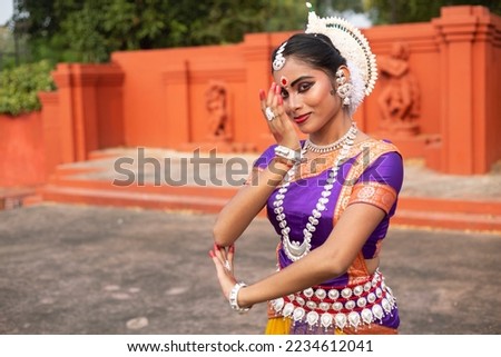 A young odissi dancer in the posture of Indian classical dance odissi. 