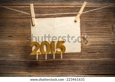 Paper notes hanging on rope with golden 2015 figures